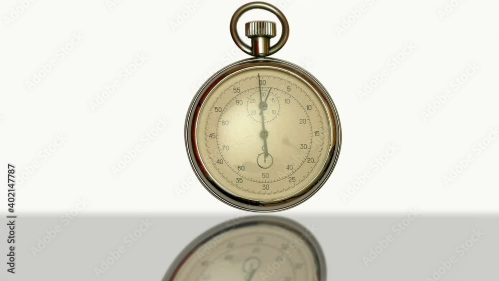 Face Dial of Stopwatch On A White Background / Antique stopwatch, clock, arrow, which moves in a circle of old clock face on a white background. Reflected on the surface Face Dial of Stopwatch On A White Background / Antique stopwatch, clock, arrow, which moves in a circle of old clock face on a white background. Reflected on the surface