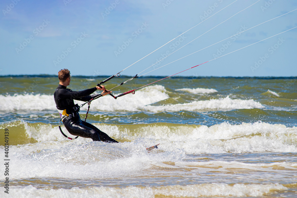 kiteboarder floats on the waves of the cold Baltic sea