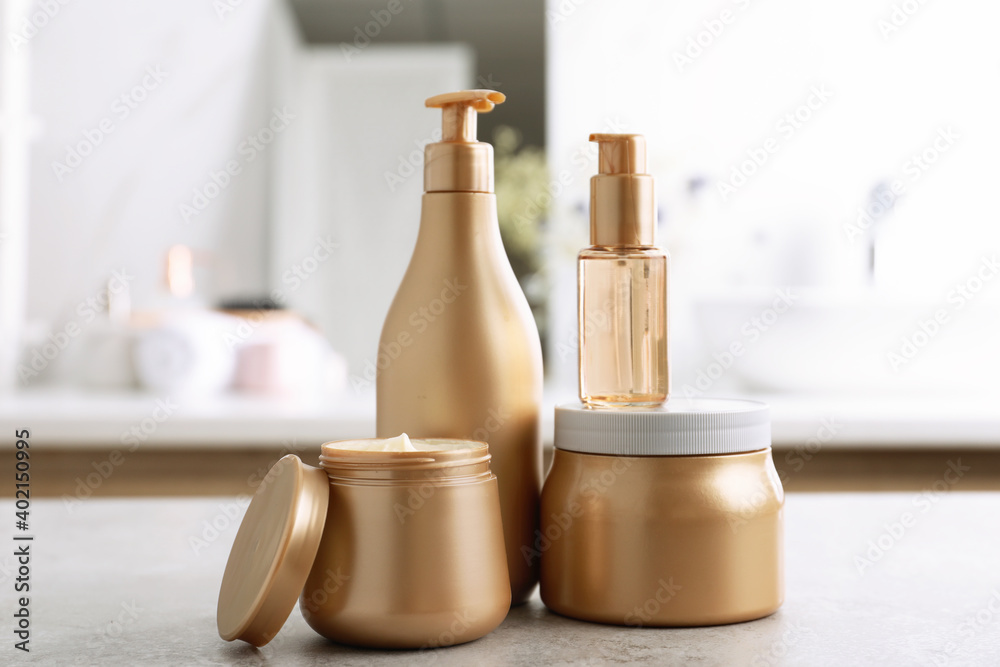Different hair care products on table in bathroom Different hair care products on table in bathroom