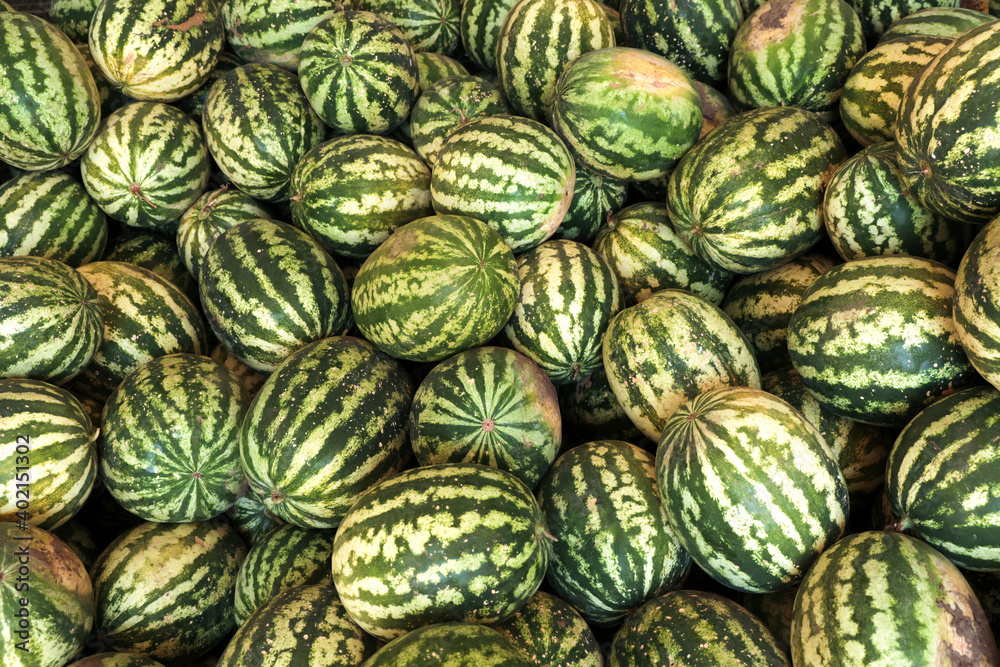 Delicious ripe watermelons as background, top view