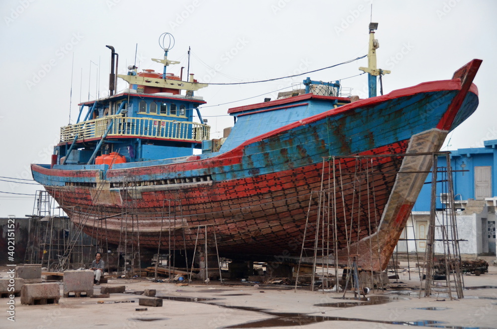 Traditional wooden cargo ship (Pinisi) in the Muara Angke harbor, Jakarta, Indonesia Traditional wooden cargo ship (Pinisi) in the Muara Angke harbor, Jakarta, Indonesia