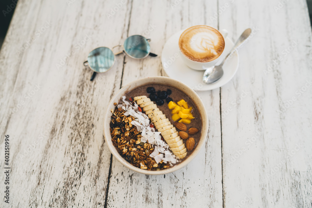 Cup of coffee and breakfast bowl with yogurt Cup of coffee and breakfast bowl with yogurt