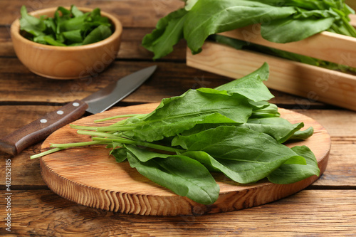 Fresh green sorrel leaves on wooden table, closeup