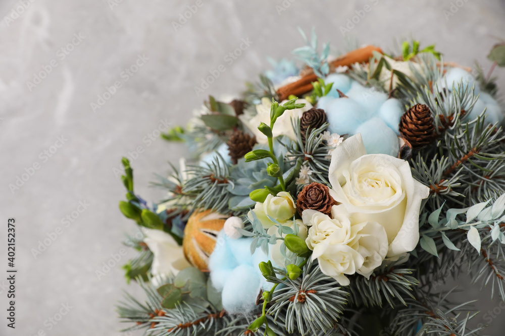 Beautiful wedding winter bouquet on grey table, top view. Space for text
