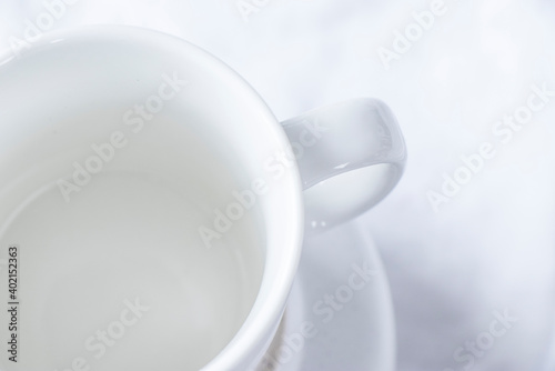 white cup and saucer