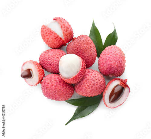 Pile of fresh ripe lychees with green leaves on white background, top view
