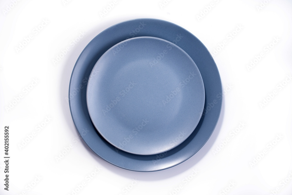 Empty Matte Navy Blue Dish Set isolated on white background top view Empty Matte Navy Blue Dish Set isolated on white background top view