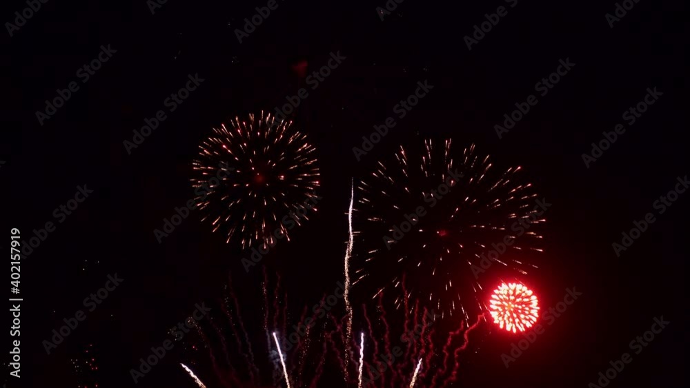 A huge fireworks display filling the darkness with light and smoke.
