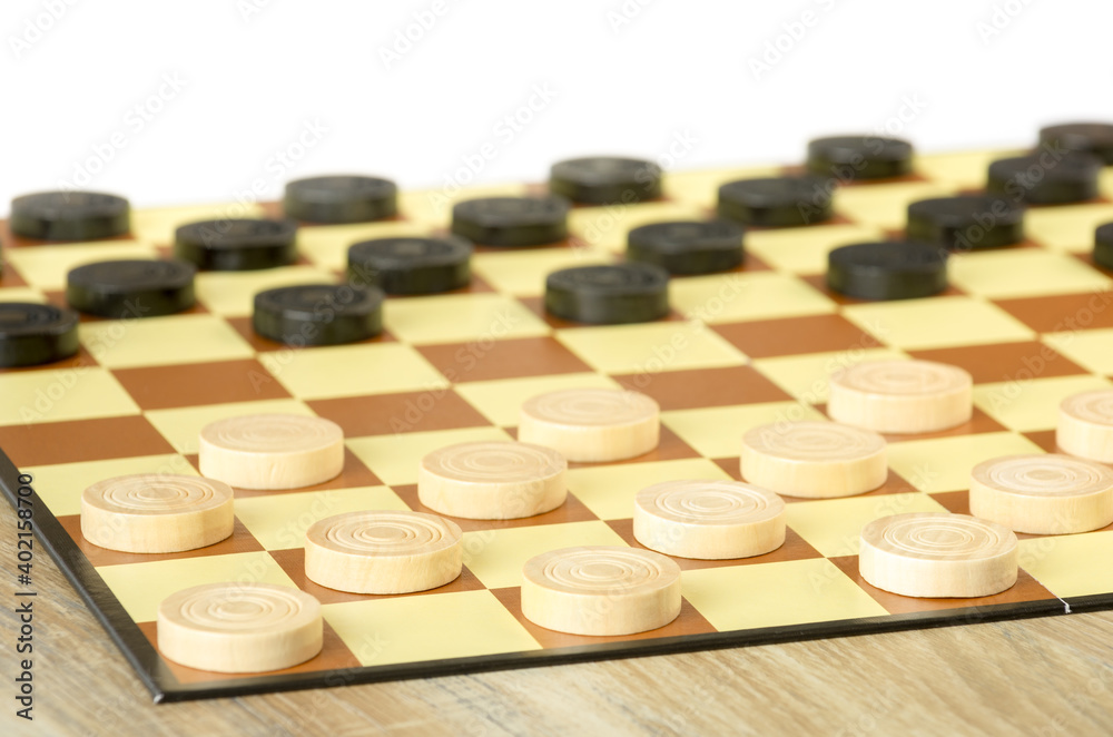 checkers or draughts is a board game. Close Up of wooden round checkers. white background. checkers or draughts is a board game. Close Up of wooden round checkers. white background.