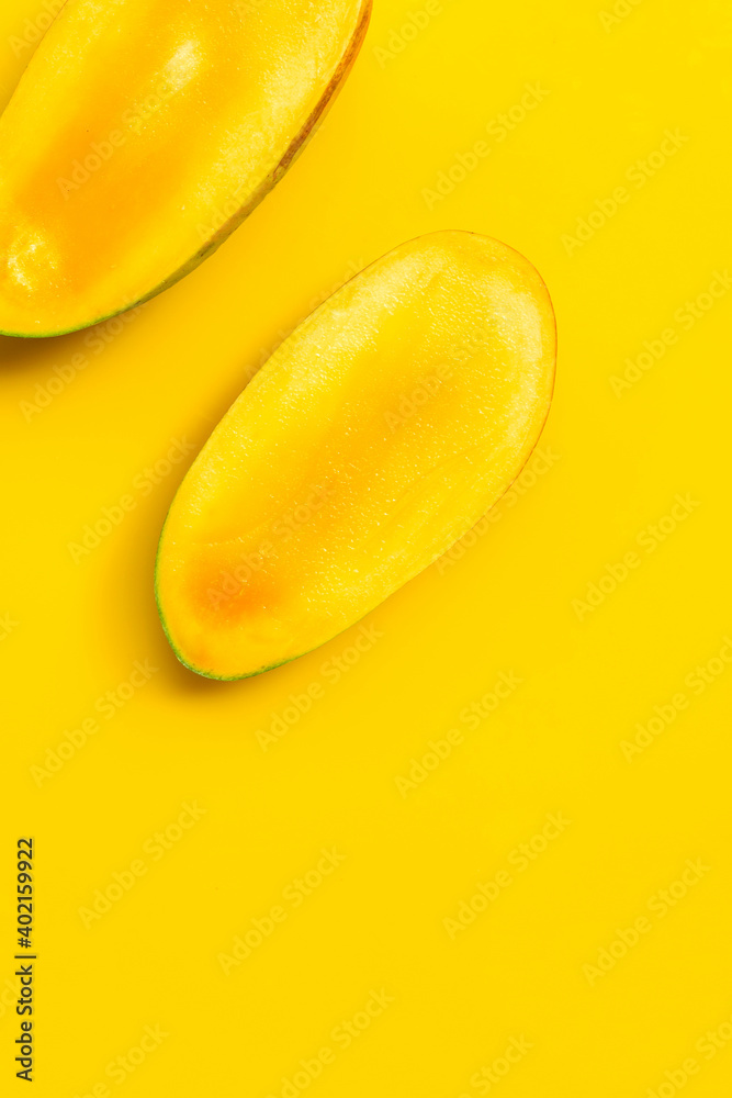 Mango on yellow background. Tropical sweet fruit concept. Mango on yellow background. Tropical sweet fruit concept.
