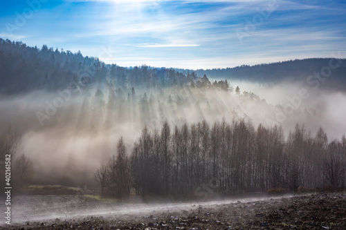 Fog falling to the bottom of the mountain valley © Fotoforce