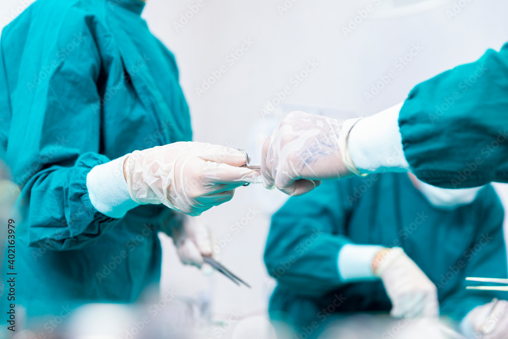The surgeon is working in a hospital operating room. Healthcare and Medicine. Doctor posing with mask in the emergency room. The surgeon is working in a hospital operating room. Healthcare and Medicine. Doctor posing with mask in the emergency room.