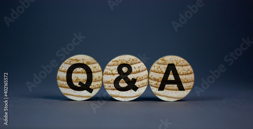 Question and answer symbol. Concept words 'Q and A - question and answer' on wooden circles on a beautiful grey background. Business and question and answer concept. Copy space. photo