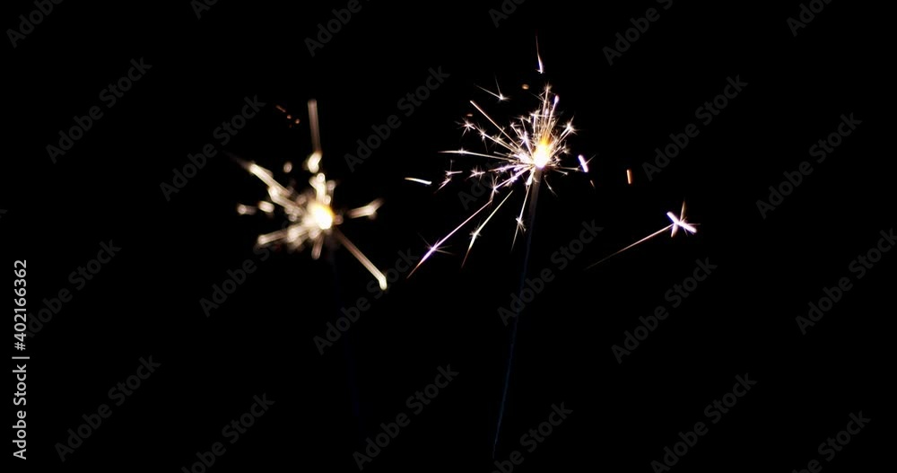 Lightening Christmas sparkler on the black background. Christmas sparkler concept. Bengal lights are burning on a black background. Holiday party concept. Christmas and newyear party sparkler.