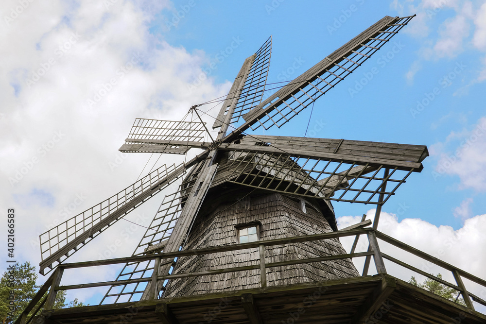 Old historic wooden windmill in detail in Latvia, blue sky