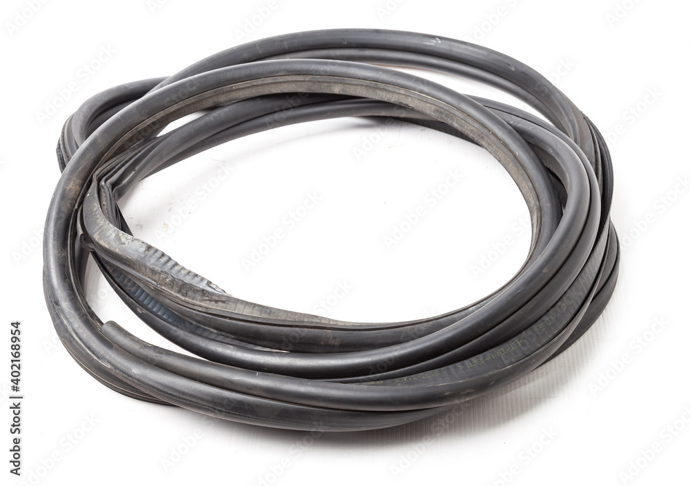 Rolled up black rubber sealant for elements of the car body, doors or trunk, for noise insulation, thermal and sound, preventing heat loss in the car interior. Sealing gasket for repair in a workshop. Rolled up black rubber sealant for elements of the car body, doors or trunk, for noise insulation, thermal and sound, preventing heat loss in the car interior. Sealing gasket for repair in a workshop.