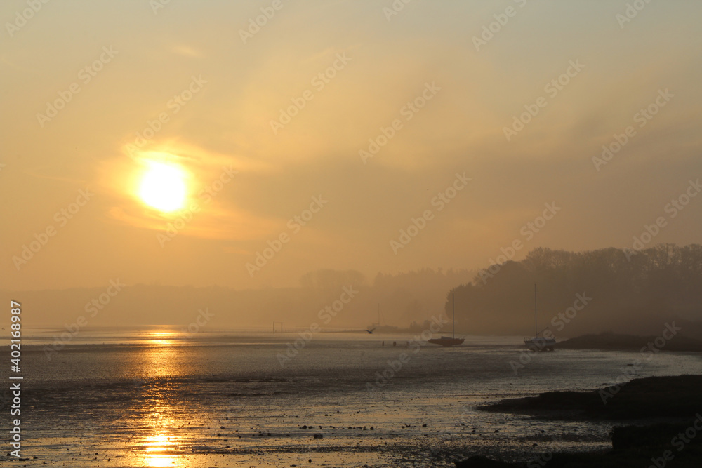 Sunrise in winter over Orwell River near Ipswich in Suffolk, East of England