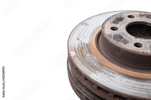 Pair of old brake discs covered with rust on a white isolated background in a photography studio. Seasonal repair of suspension and brake system in workshop or sale of spare parts for auto analysis.