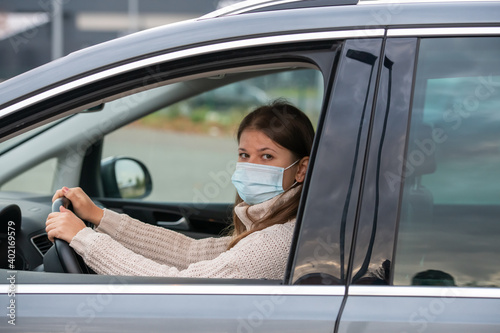 woman in mask driving