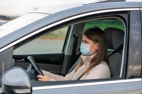 woman in mask driving