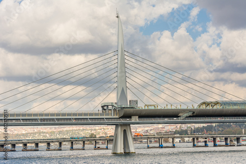 A modern The Golden Horn Metro Bridge across the Golden Horn at Bosphorus strait in Istanbul, Turkey against cloudy sky