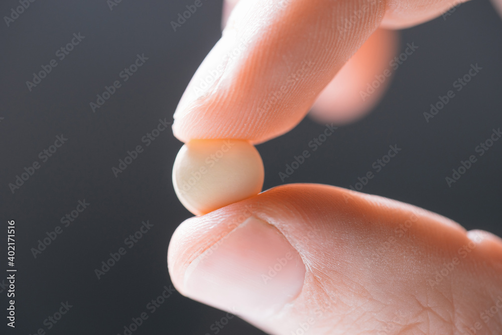 close up. white tablet in the doctor's hand . close up. white tablet in the doctor's hand .