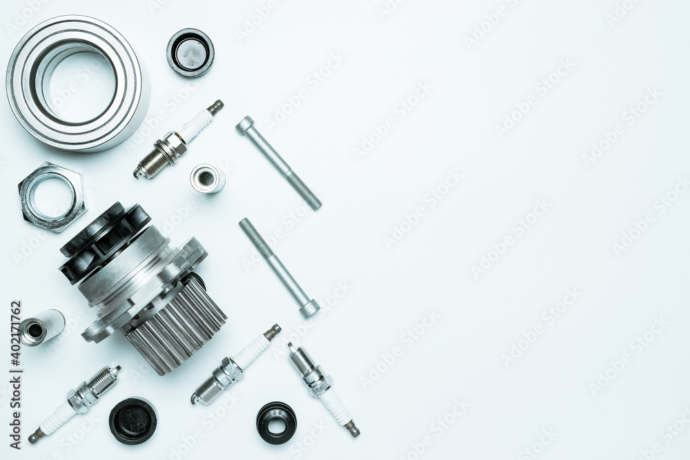 Spare parts. Auto motor mechanic spare or automotive piece on white background. Set of new metal car part. Flat lay, top view, copy space. Spare parts. Auto motor mechanic spare or automotive piece on white background. Set of new metal car part. Flat lay, top view, copy space.