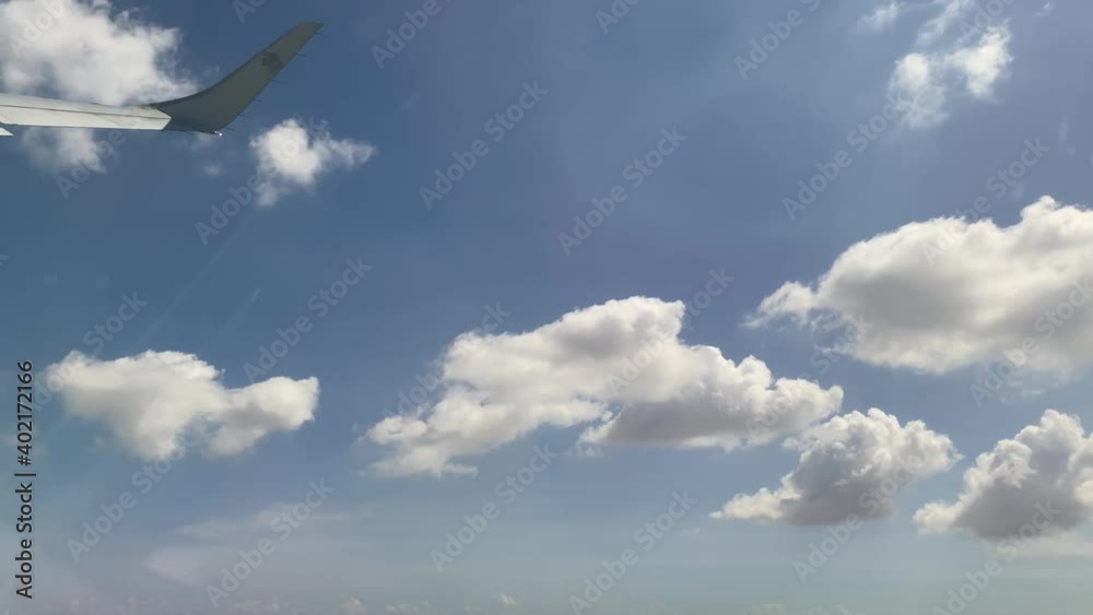 Airplane wing seen from the window while in flight on a sunny afternoon Airplane wing seen from the window while in flight on a sunny afternoon