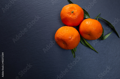 fresh tangerines on a stone slab. citrus fruit top view