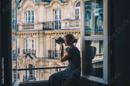 Woman overlooking Paris in Window with camera © Alexandra Phillips