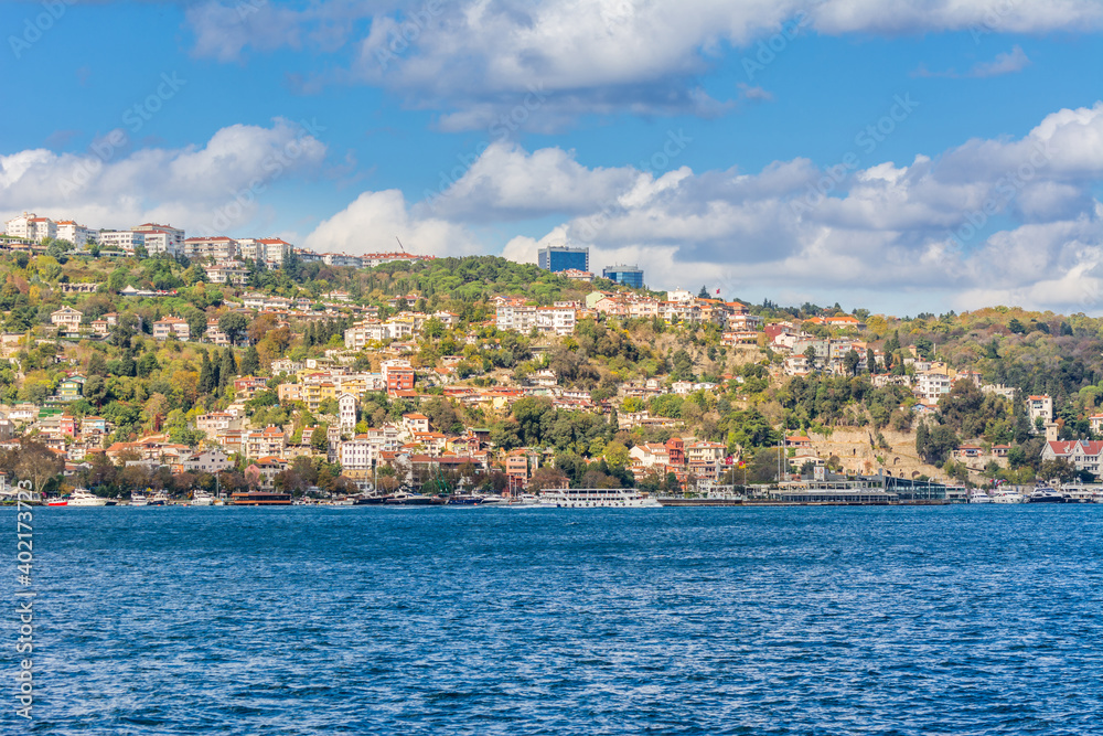 Cityscape of  Golden horn with ancient and modern buildings in Istanbul Turkey from the Bosphorus strait on a sunny day with background cloudy sky