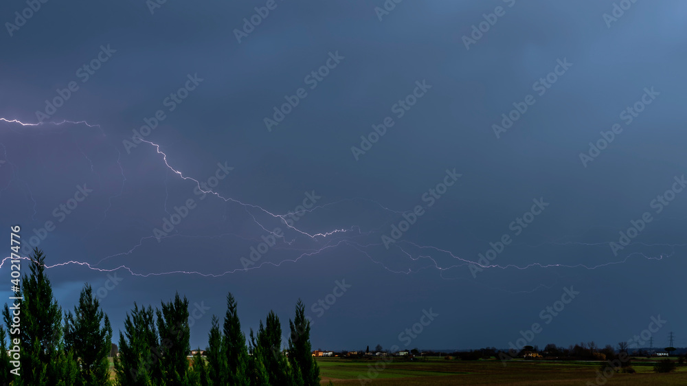 A strong storm over the countryside with huge lightning and thunder at the first light of the new day A strong storm over the countryside with huge lightning and thunder at the first light of the new day
