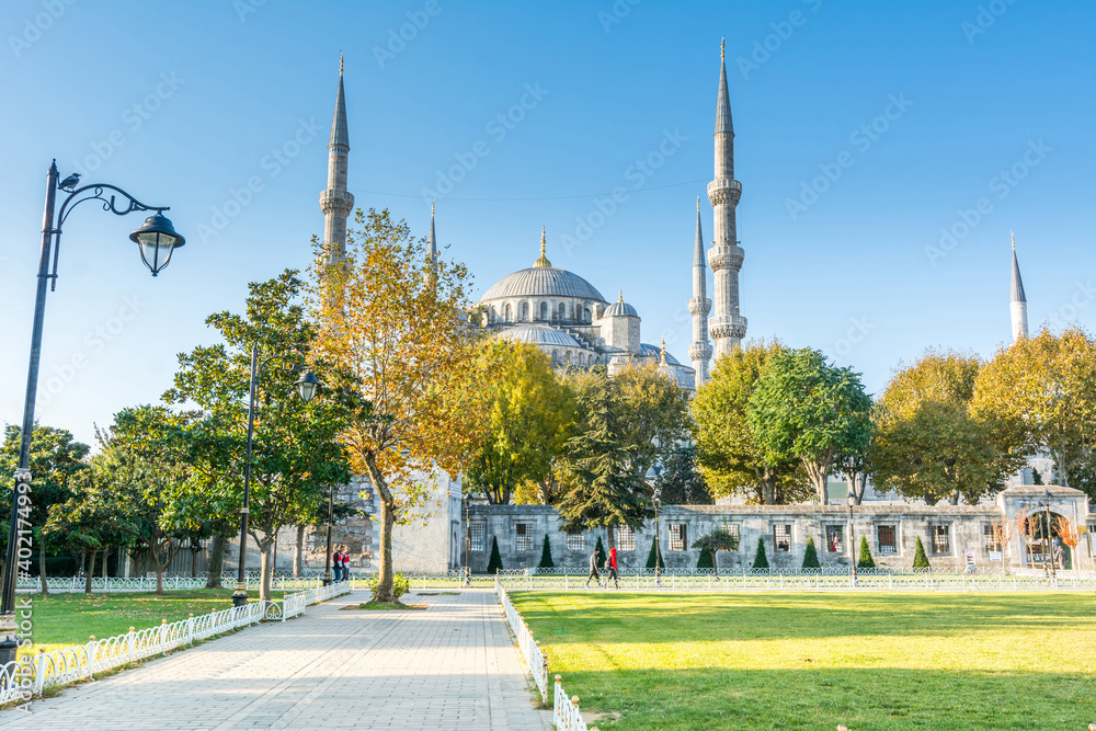 Tourists visiting Blue Mosque,  also called the Sultan Ahmed Mosque or Sultan Ahmet Mosque under sunlight in the morning in autumn in Istanbul, Turkey