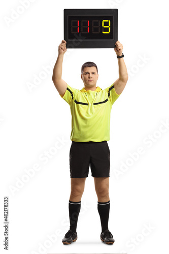 Картината върху платно Full length portrait of football referee holding a substitute board