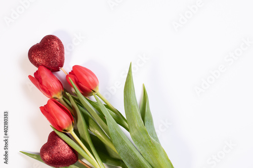 St Valentines day composition with bouquet of tullips and two red hearts