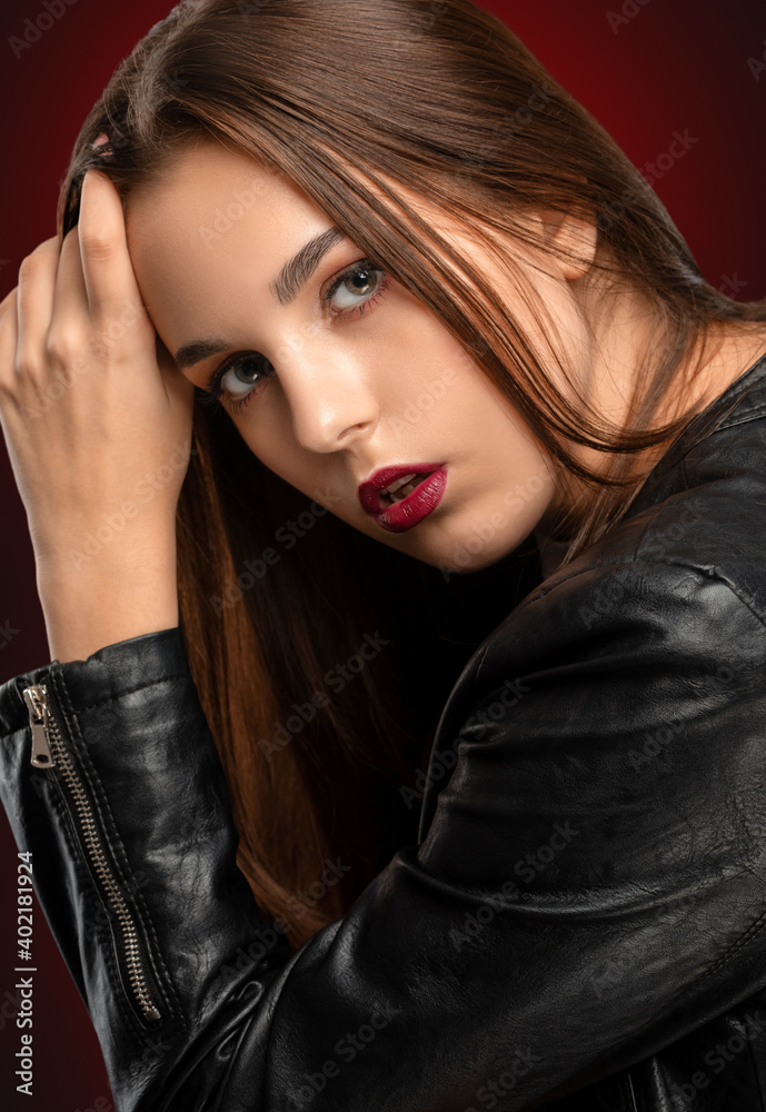 Brunette girl with beautiful makeup, with clean skin, long hair in a black leather jacket. makeup concept Brunette girl with beautiful makeup, with clean skin, long hair in a black leather jacket. makeup concept