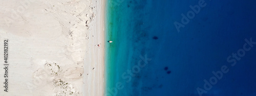 Aerial drone ultra wide panoramic photo of tropical exotic beach with deep turquoise crystal clear sea