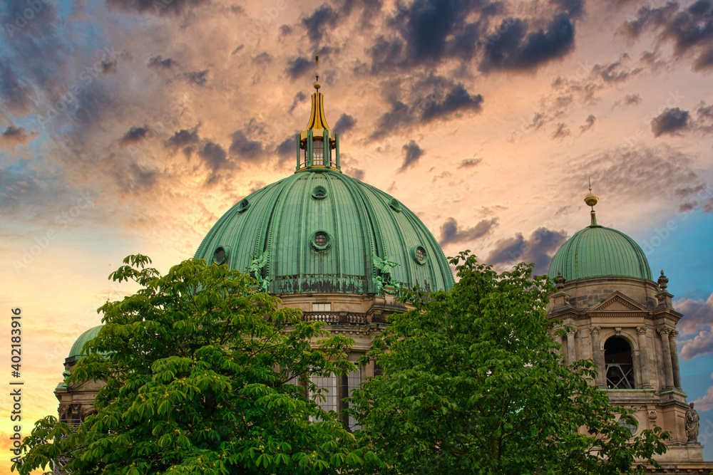 The dome of the Berlin Cathedral behind trees in Berlin