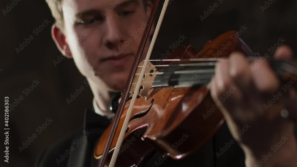 Close Up Of Male Violinist Hand And Bow During Performance Close Up Of Male Violinist Hand And Bow During Performance