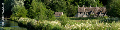 GLOUCESTERSHIRE, UK:  Panorama view of the medieval weavers cottages at Arlington Row in  Bibury photo