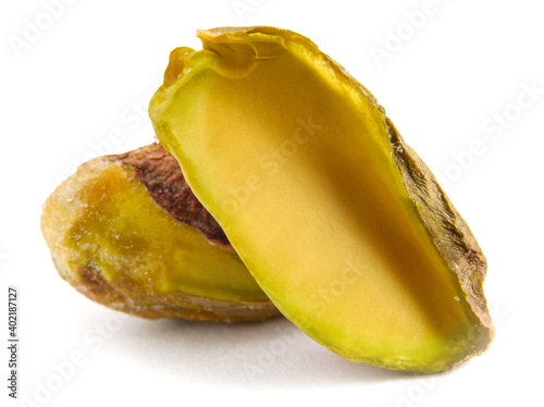 The pistachio core and half are isolated on a white background.