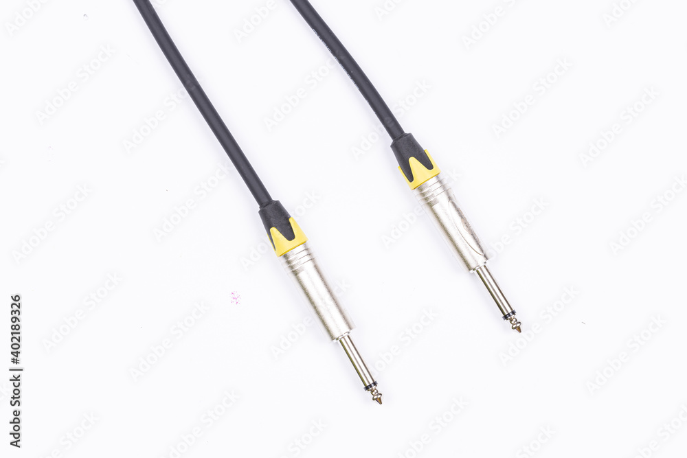 Audio guitar and microphone cable isolated above white background Audio guitar and microphone cable isolated above white background