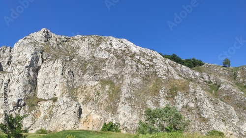 Bottom view of a beautiful mountain. At the foot of the mountain. Blue sky background