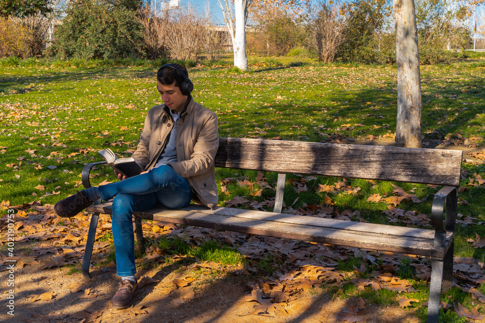 Man sitting in a park reading a book Man sitting in a park reading a book