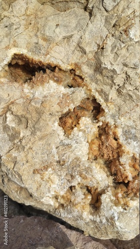 closeup photo of limestone with quartz secretion inside. Quartz in a limestone cavern