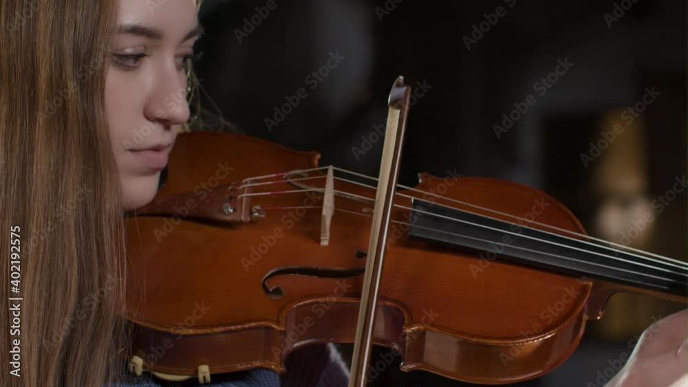 Side View Close Up Of Female Violinist Playing Side View Close Up Of Female Violinist Playing
