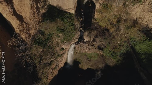Detail of waterfall and massive bridge of Puente Nuevo, Andalusia, Spain