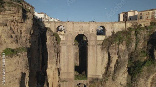 Moving backwards fast from Puente Nuevo bridge, revealing the town of Ronda, Andalusia, Spain
