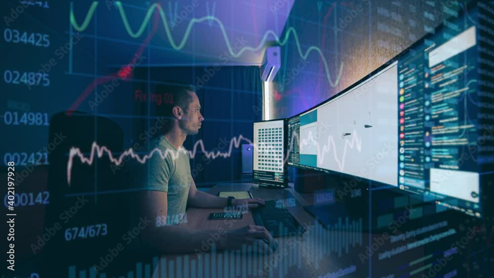 The engineer working on widescreen computer behind holographic layer