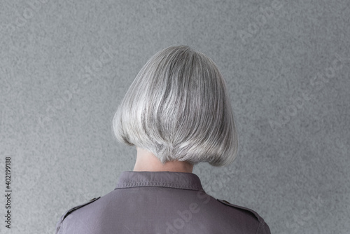 Silver-haired lady in purple shirt